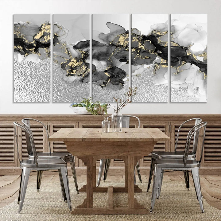 The Gray Marble Fluid Effect Wall Art Abstract Canvas Print, featuring black, white, and gold textured patterns, is crafted on museum-quality canvases and finished with a UV-protective coating. This piece adds sophistication to any space.