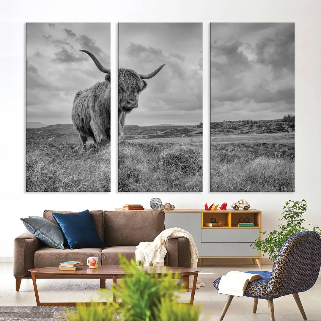 Grayscale Highland Cow Cattle Canvas Art Print Wall Art showcases a majestic highland cow in a grassy landscape. Created on museum-quality canvas with a UV-protective coating, this masterpiece promises enduring vibrancy and sophistication.