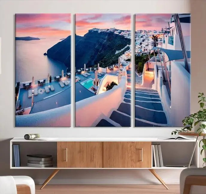 Greece Santorini Wall Art Landscape Canvas Print showcases a coastal village at sunset, featuring white buildings and an ocean view. The gallery-wrapped image is printed on museum-quality canvas for lasting beauty.