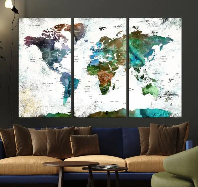 The Green Color Map of World Wall Art Canvas Print, featuring colorful continents and handmade in the USA, is displayed on the wall. These museum-quality canvases are finished with a UV-protective coating to ensure lasting vibrancy.