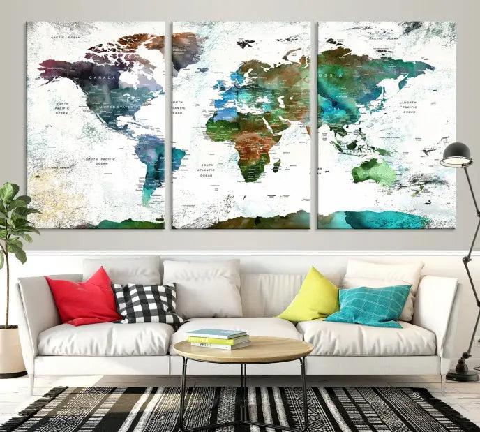 The Green Color Map of World Wall Art Canvas Print, featuring colorful continents and handmade in the USA, is displayed on the wall. These museum-quality canvases are finished with a UV-protective coating to ensure lasting vibrancy.