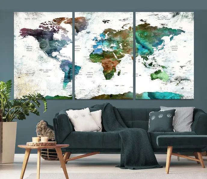 The Green Color Map of World Wall Art Canvas Print, featuring colorful continents and handmade in the USA, is displayed on the wall. These museum-quality canvases are finished with a UV-protective coating to ensure lasting vibrancy.