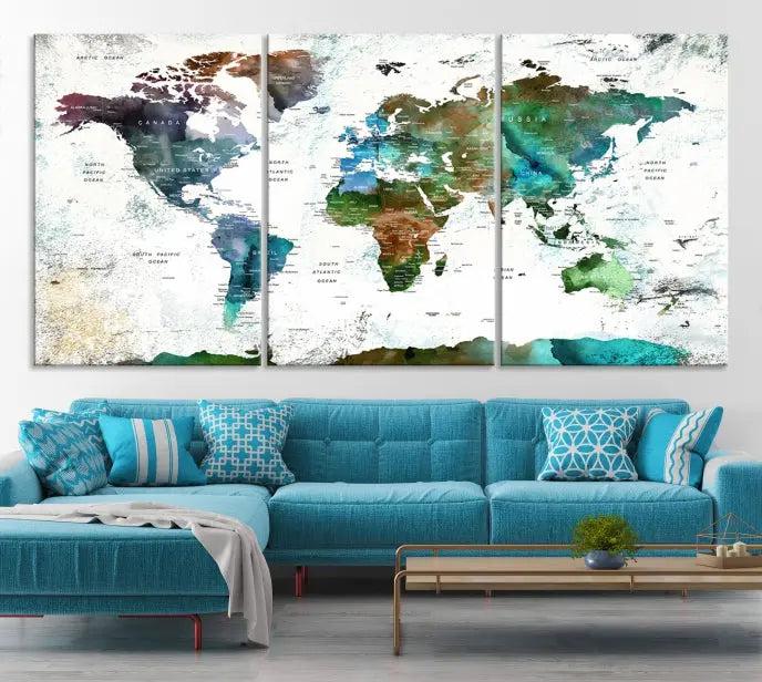 The Green Color Map of World Wall Art Canvas Print, featuring colorful continents and handmade in the USA, is displayed on the wall. These museum-quality canvases are finished with a UV-protective coating to ensure lasting vibrancy.