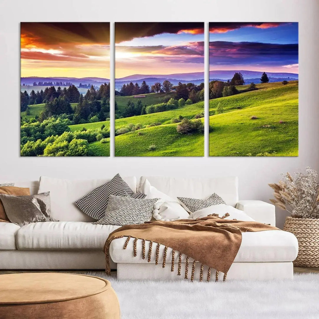 The room features a large triptych of the Green Hills and Sunset Wall Art Print, showcasing a scenic landscape with lush greenery and a vibrant sky.