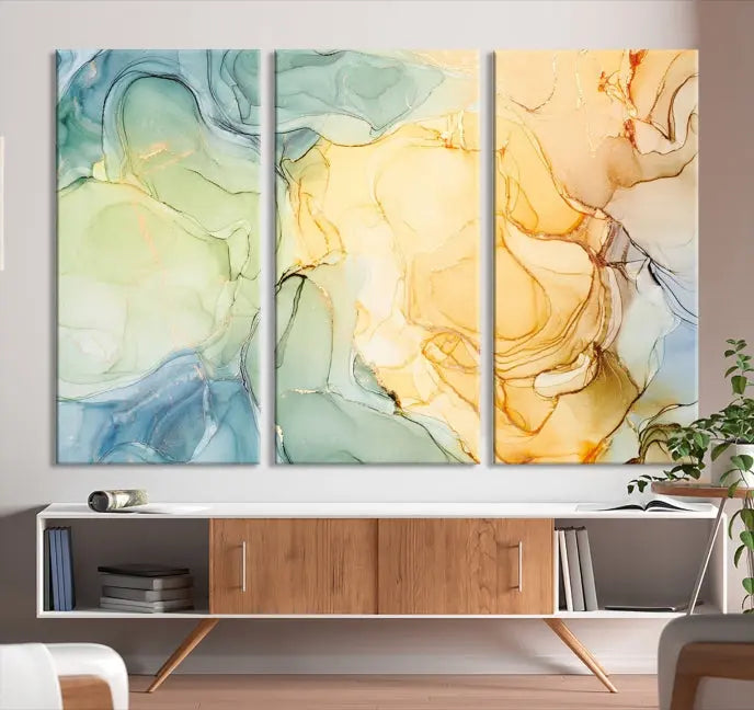 The Green and Yellow Marble Fluid Effect Wall Art Abstract Canvas Wall Art Print in the living room is a striking piece. This three-panel artwork, gallery wrapped on museum-quality canvas, ensures it stands out as a centerpiece in any setting.