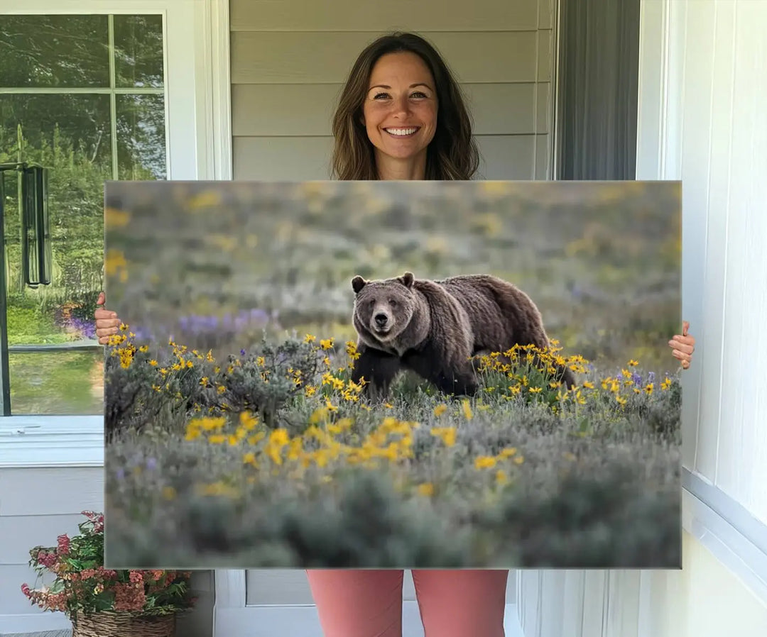 The Grizzly Bears Wall Art, titled "Grizzly 399 in Wild Flowers Wall Art Canvas Print," showcases a majestic bear meandering through vibrant yellow flowers. This piece brings the wild beauty of Grand Teton into your home.