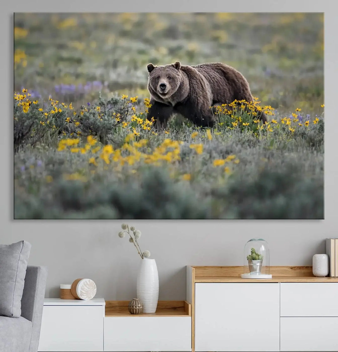 The Grizzly Bears Wall Art, titled "Grizzly 399 in Wild Flowers Wall Art Canvas Print," showcases a majestic bear meandering through vibrant yellow flowers. This piece brings the wild beauty of Grand Teton into your home.