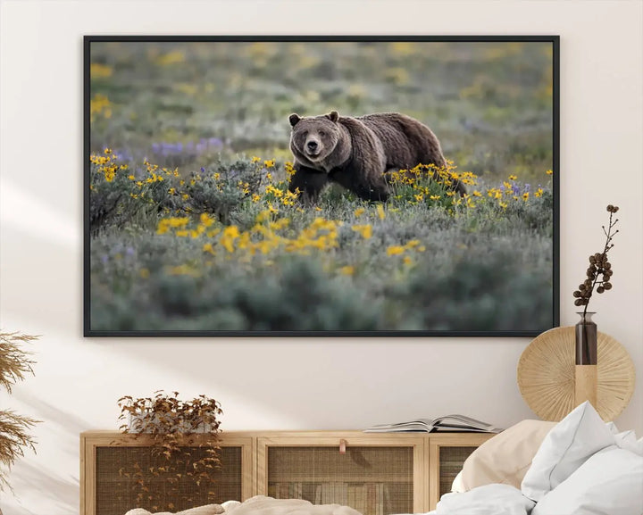 The Grizzly Bears Wall Art, titled "Grizzly 399 in Wild Flowers Wall Art Canvas Print," showcases a majestic bear meandering through vibrant yellow flowers. This piece brings the wild beauty of Grand Teton into your home.