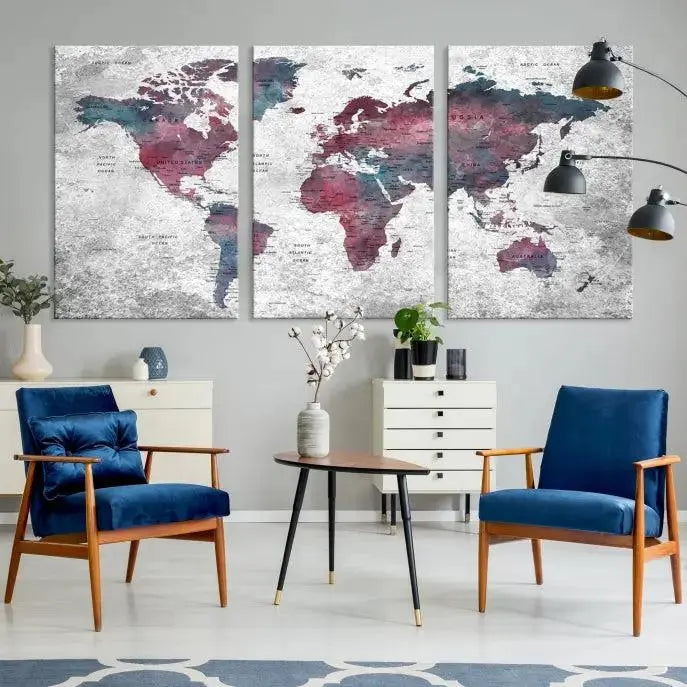 The living room features the Grunge Watercolor World Map Wall Art Canvas Print on a textured gray wall. The map is printed on museum-quality canvas with hand-assembled frames, providing an elegant touch, while its UV-protective coating ensures longevity.