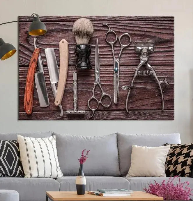 The Hairdresser Tools Wall Art Canvas Print, presented in three panels, showcases vintage barber tools against a wood grain backdrop.