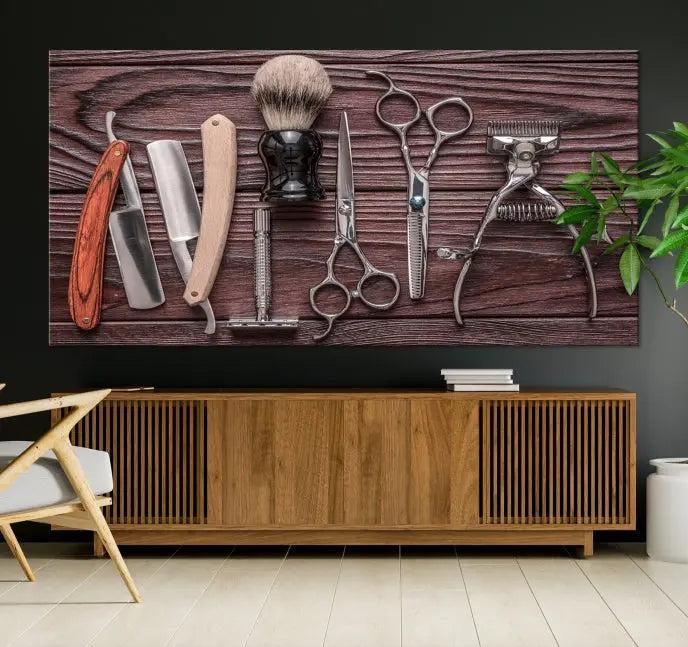 The Hairdresser Tools Wall Art Canvas Print, presented in three panels, showcases vintage barber tools against a wood grain backdrop.