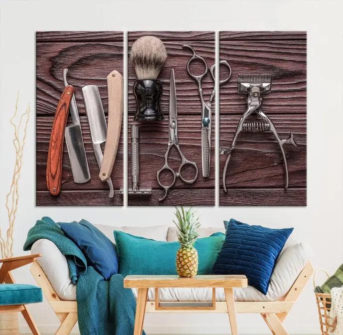 The Hairdresser Tools Wall Art Canvas Print, presented in three panels, showcases vintage barber tools against a wood grain backdrop.