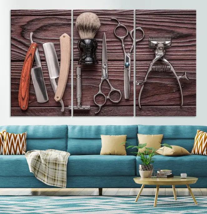 The Hairdresser Tools Wall Art Canvas Print, presented in three panels, showcases vintage barber tools against a wood grain backdrop.