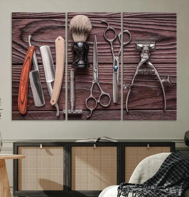 The Hairdresser Tools Wall Art Canvas Print, presented in three panels, showcases vintage barber tools against a wood grain backdrop.