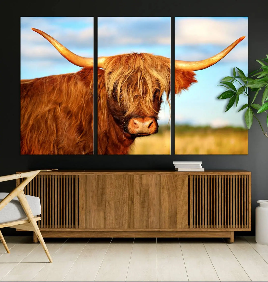 A triptych of Highland Cow Canvas Wall Art Print Cattle Art, featuring a shaggy-haired highland cow with long horns, elegantly adorns the space. Each museum-quality canvas piece is professionally hand-assembled and includes a UV-protective coating to maintain its vibrant colors over time.