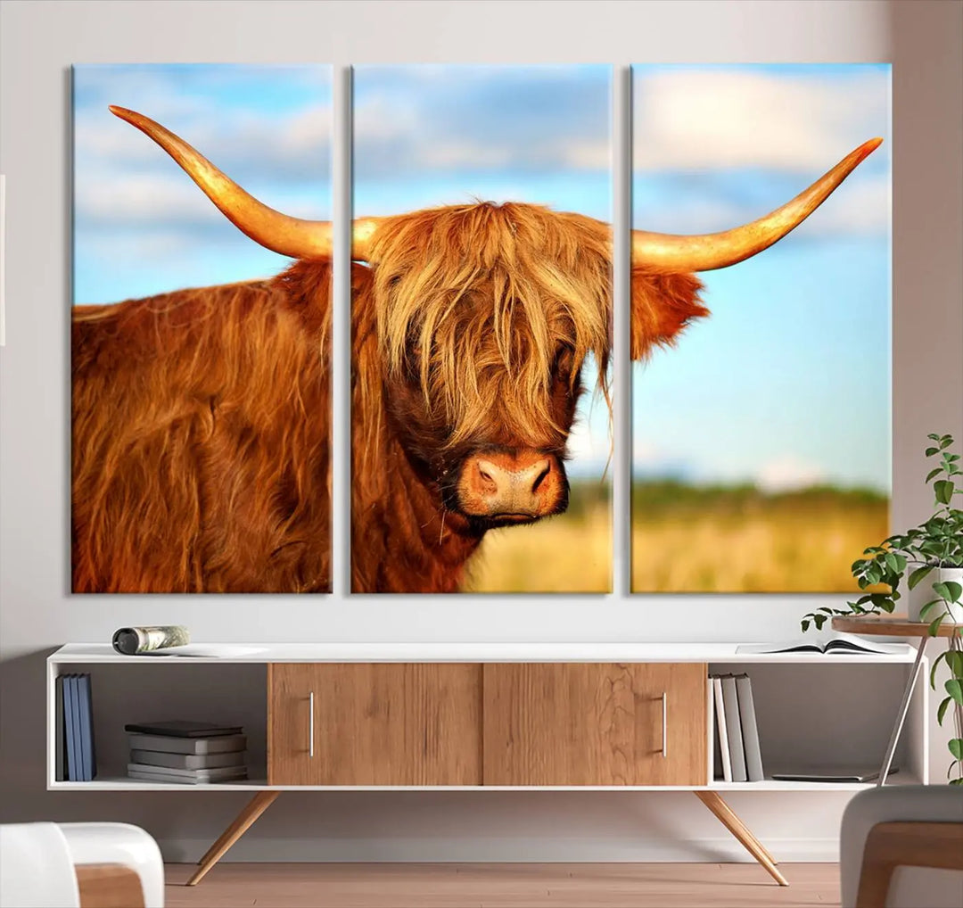 A triptych of Highland Cow Canvas Wall Art Print Cattle Art, featuring a shaggy-haired highland cow with long horns, elegantly adorns the space. Each museum-quality canvas piece is professionally hand-assembled and includes a UV-protective coating to maintain its vibrant colors over time.