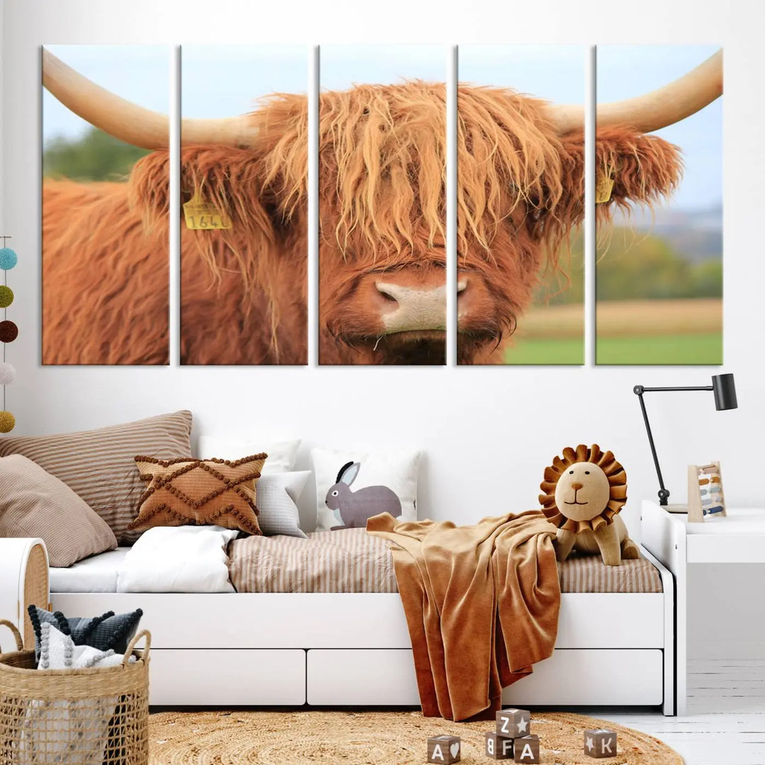 A multi-panel canvas set artwork features a close-up of a Highland cow with long horns and shaggy fur, displayed gallery-wrapped on museum-quality canvas with UV-protective coating. It hangs elegantly on a dark wall.