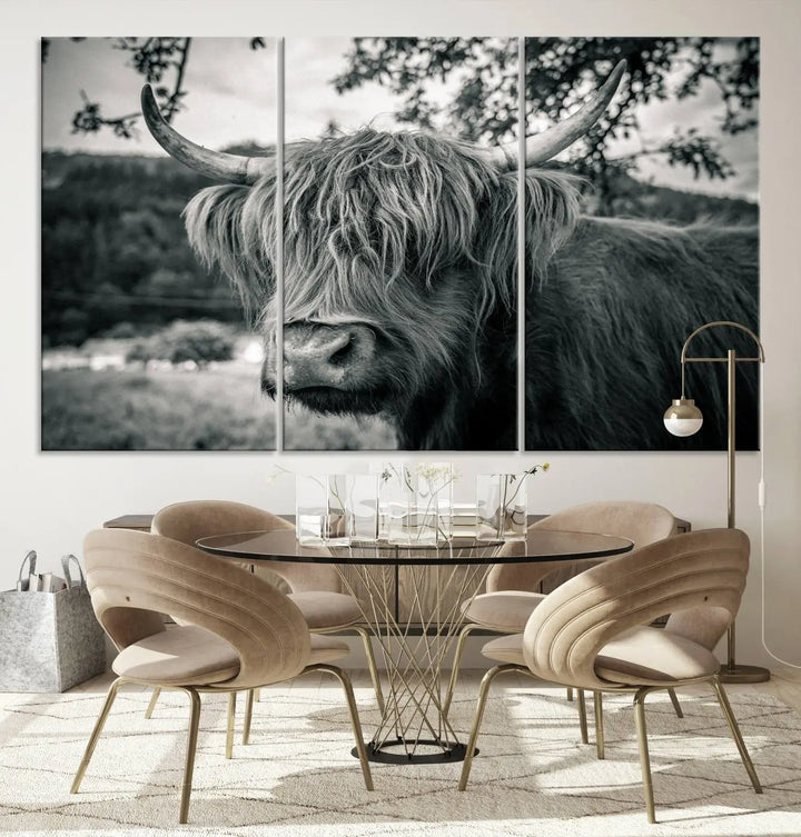 The stylish living room showcases the "Highland Cow Wall Art Canvas Print Scottish Cattle Canvas Art" displayed as a triptych on the wall. This artwork is gallery wrapped on museum-quality canvas with a UV-protective coating for lasting elegance.