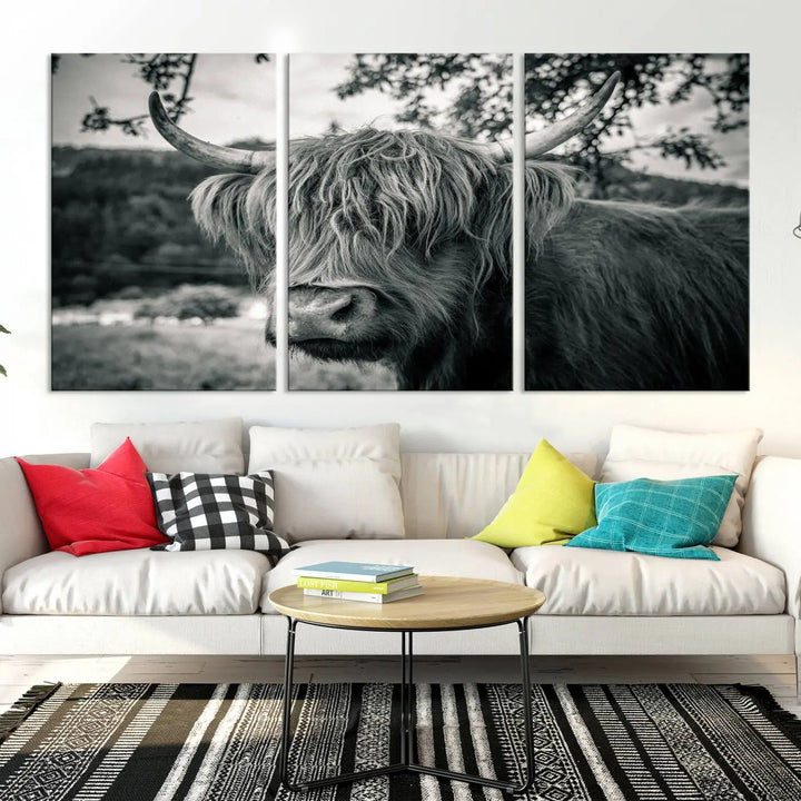 The stylish living room showcases the "Highland Cow Wall Art Canvas Print Scottish Cattle Canvas Art" displayed as a triptych on the wall. This artwork is gallery wrapped on museum-quality canvas with a UV-protective coating for lasting elegance.