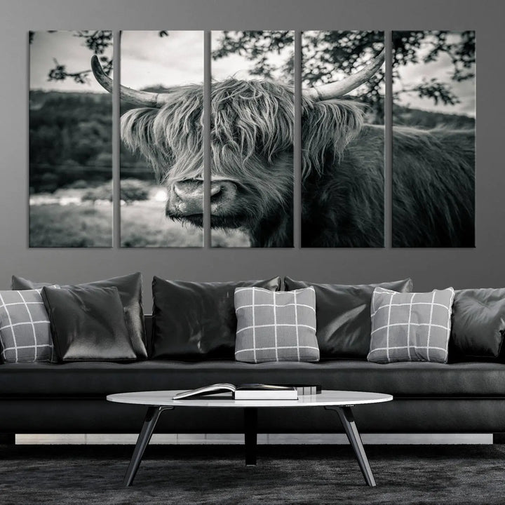 The stylish living room showcases the "Highland Cow Wall Art Canvas Print Scottish Cattle Canvas Art" displayed as a triptych on the wall. This artwork is gallery wrapped on museum-quality canvas with a UV-protective coating for lasting elegance.