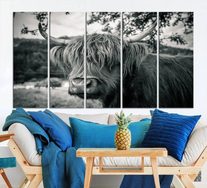 The stylish living room showcases the "Highland Cow Wall Art Canvas Print Scottish Cattle Canvas Art" displayed as a triptych on the wall. This artwork is gallery wrapped on museum-quality canvas with a UV-protective coating for lasting elegance.