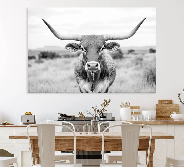 The "Highland Cow Wall Art Print," featuring a black and white depiction of a Texas Western Longhorn, elegantly adorns the wall. This Southwestern animal artwork for home is crafted as premium canvas wall art, ensuring a gallery-quality finish.