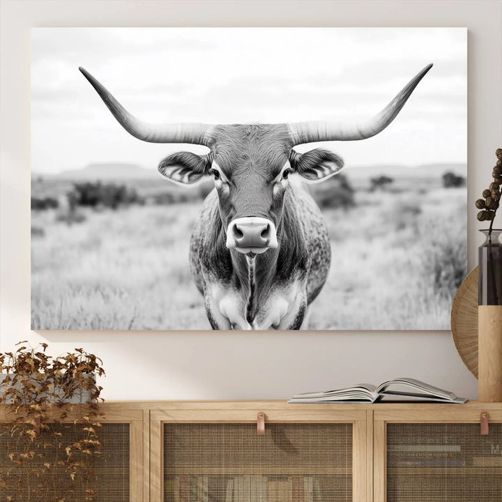 The "Highland Cow Wall Art Print," featuring a black and white depiction of a Texas Western Longhorn, elegantly adorns the wall. This Southwestern animal artwork for home is crafted as premium canvas wall art, ensuring a gallery-quality finish.