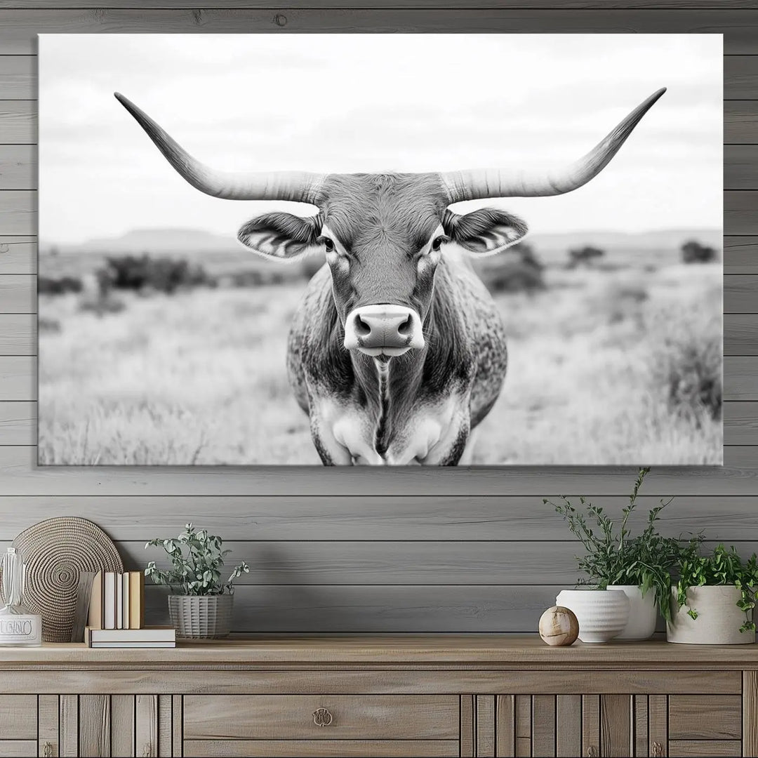 The "Highland Cow Wall Art Print," featuring a black and white depiction of a Texas Western Longhorn, elegantly adorns the wall. This Southwestern animal artwork for home is crafted as premium canvas wall art, ensuring a gallery-quality finish.