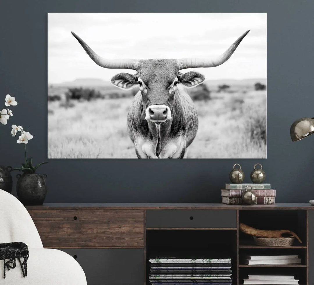 The "Highland Cow Wall Art Print," featuring a black and white depiction of a Texas Western Longhorn, elegantly adorns the wall. This Southwestern animal artwork for home is crafted as premium canvas wall art, ensuring a gallery-quality finish.