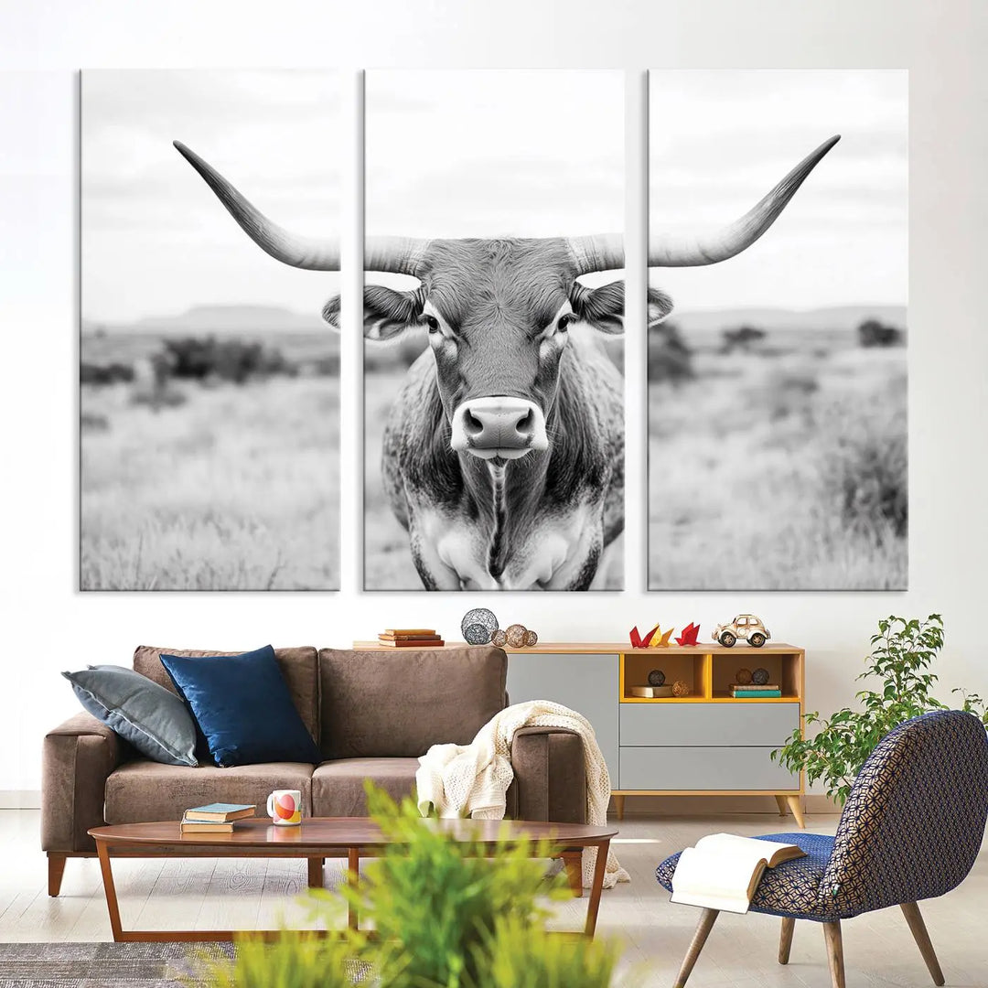 The "Highland Cow Wall Art Print," featuring a black and white depiction of a Texas Western Longhorn, elegantly adorns the wall. This Southwestern animal artwork for home is crafted as premium canvas wall art, ensuring a gallery-quality finish.