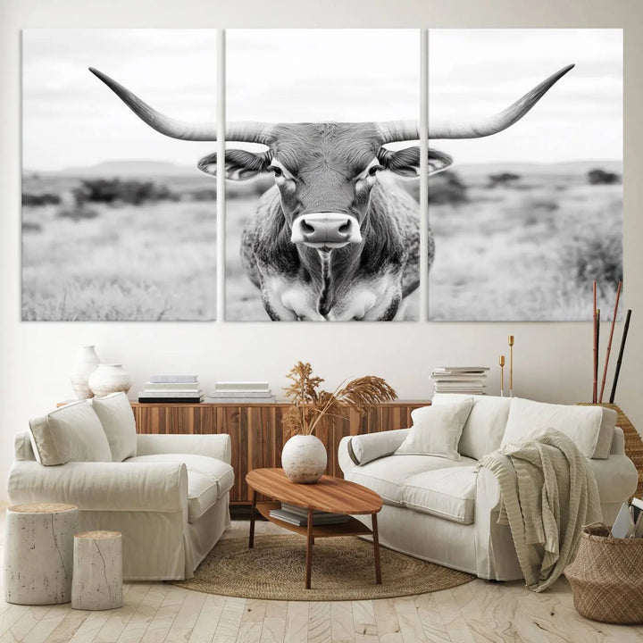 The "Highland Cow Wall Art Print," featuring a black and white depiction of a Texas Western Longhorn, elegantly adorns the wall. This Southwestern animal artwork for home is crafted as premium canvas wall art, ensuring a gallery-quality finish.