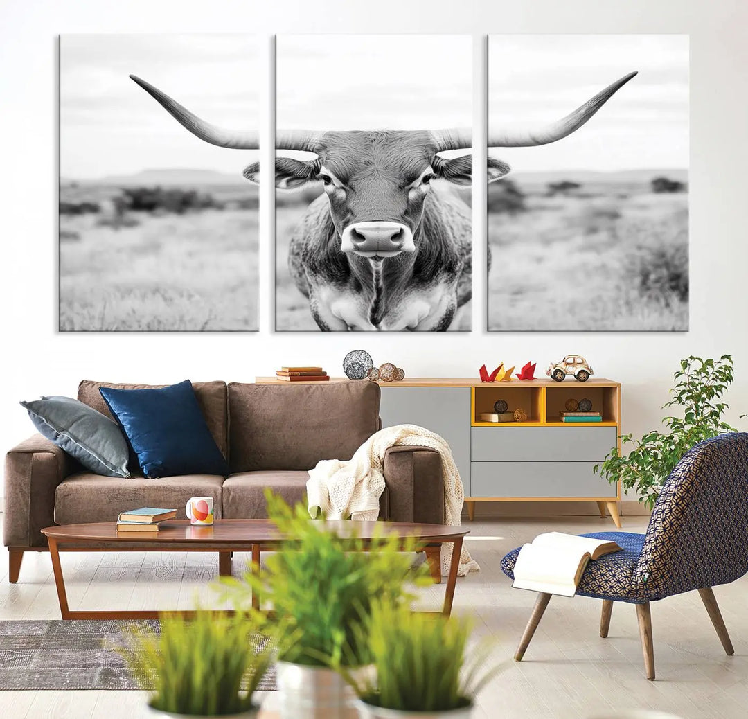 The "Highland Cow Wall Art Print," featuring a black and white depiction of a Texas Western Longhorn, elegantly adorns the wall. This Southwestern animal artwork for home is crafted as premium canvas wall art, ensuring a gallery-quality finish.