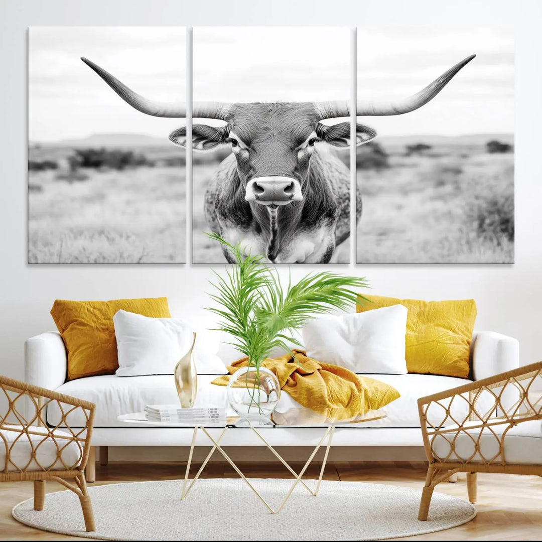 The "Highland Cow Wall Art Print," featuring a black and white depiction of a Texas Western Longhorn, elegantly adorns the wall. This Southwestern animal artwork for home is crafted as premium canvas wall art, ensuring a gallery-quality finish.