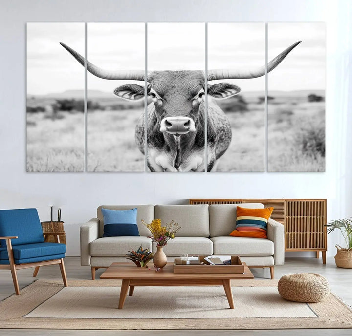 The "Highland Cow Wall Art Print," featuring a black and white depiction of a Texas Western Longhorn, elegantly adorns the wall. This Southwestern animal artwork for home is crafted as premium canvas wall art, ensuring a gallery-quality finish.