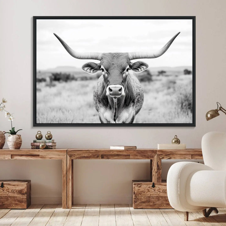 The "Highland Cow Wall Art Print," featuring a black and white depiction of a Texas Western Longhorn, elegantly adorns the wall. This Southwestern animal artwork for home is crafted as premium canvas wall art, ensuring a gallery-quality finish.