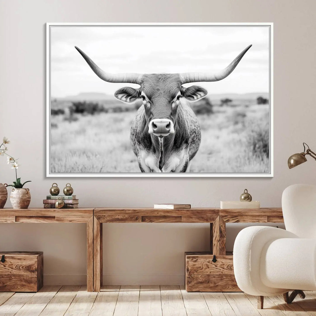 The "Highland Cow Wall Art Print," featuring a black and white depiction of a Texas Western Longhorn, elegantly adorns the wall. This Southwestern animal artwork for home is crafted as premium canvas wall art, ensuring a gallery-quality finish.