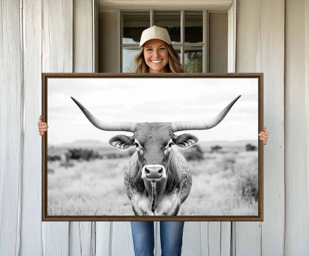 The "Highland Cow Wall Art Print," featuring a black and white depiction of a Texas Western Longhorn, elegantly adorns the wall. This Southwestern animal artwork for home is crafted as premium canvas wall art, ensuring a gallery-quality finish.