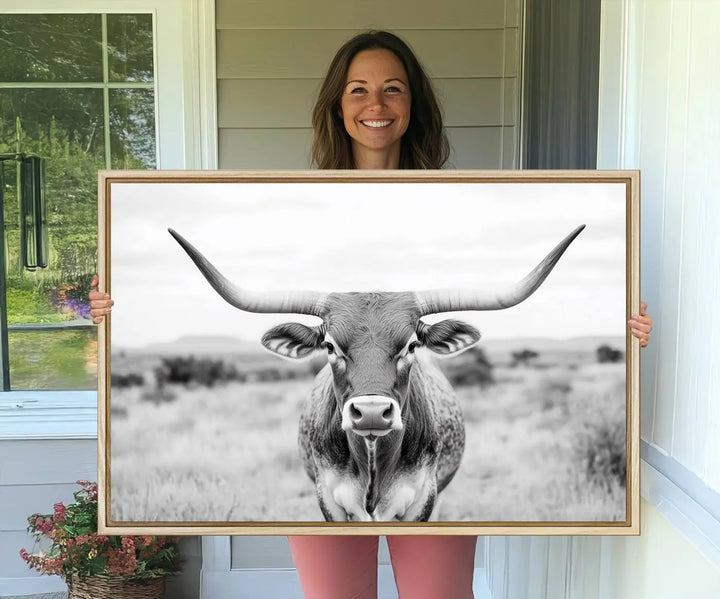 The "Highland Cow Wall Art Print," featuring a black and white depiction of a Texas Western Longhorn, elegantly adorns the wall. This Southwestern animal artwork for home is crafted as premium canvas wall art, ensuring a gallery-quality finish.