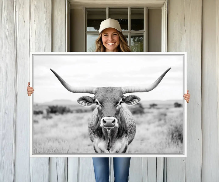 The "Highland Cow Wall Art Print," featuring a black and white depiction of a Texas Western Longhorn, elegantly adorns the wall. This Southwestern animal artwork for home is crafted as premium canvas wall art, ensuring a gallery-quality finish.