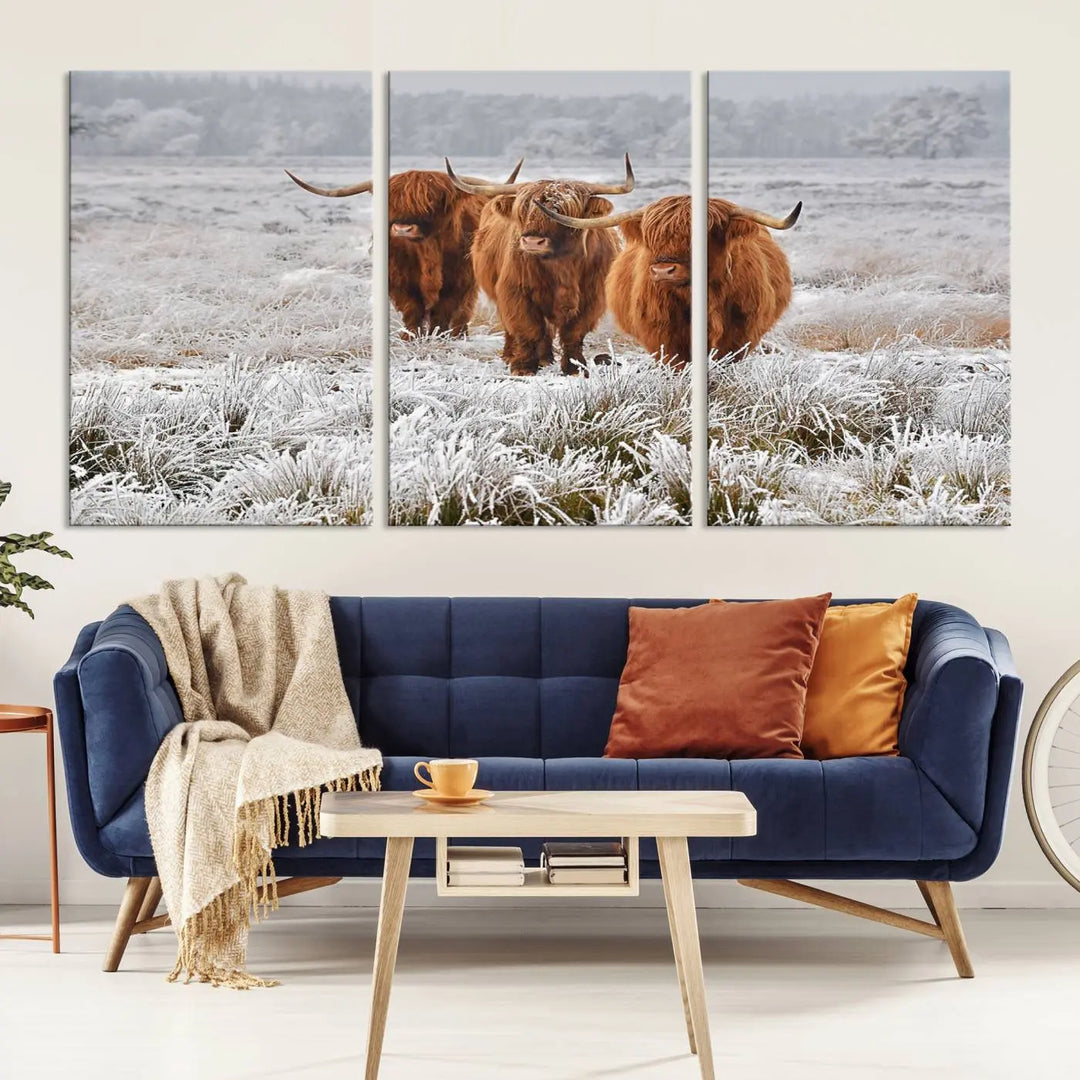 The "Highland Cows in Snow Canvas Art Highland Cattle Picture Art Farmhouse Art," featuring three highland cows walking through a frosty field, is printed on museum-quality canvas and gallery wrapped. It includes a UV-protective coating to ensure lasting beauty.