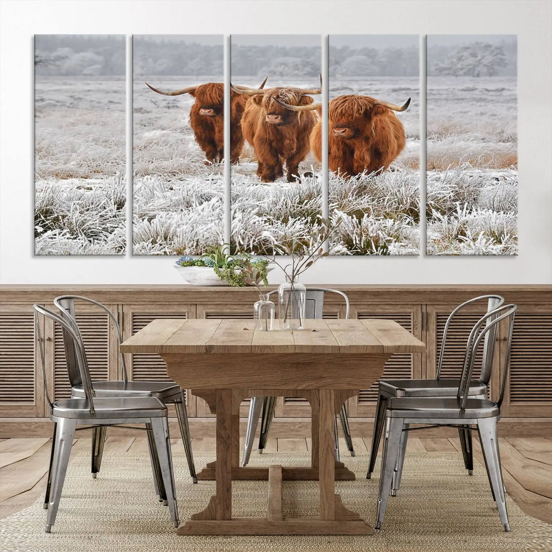 The "Highland Cows in Snow Canvas Art Highland Cattle Picture Art Farmhouse Art," featuring three highland cows walking through a frosty field, is printed on museum-quality canvas and gallery wrapped. It includes a UV-protective coating to ensure lasting beauty.