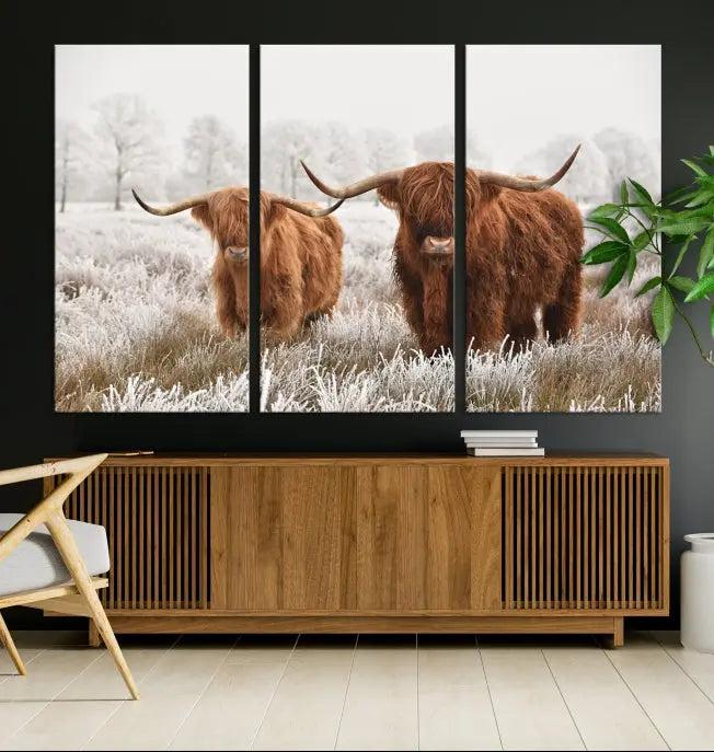 The living room prominently features the Highland Cows in Winter Canvas Wall Art, a striking triptych of animal photography depicting two cows in a frosty field, elegantly displayed above the couch.