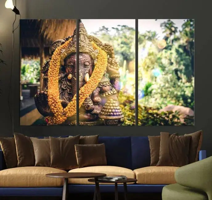 A set of three panels depicting the Hindu deity Lord Ganesha, embellished with a yellow garland, gracefully decorates a wall. This gallery-wrapped artwork, known as the Hinduism Statue Wall Art Canvas Print, is meticulously crafted on museum-quality canvas for an exquisite finish.