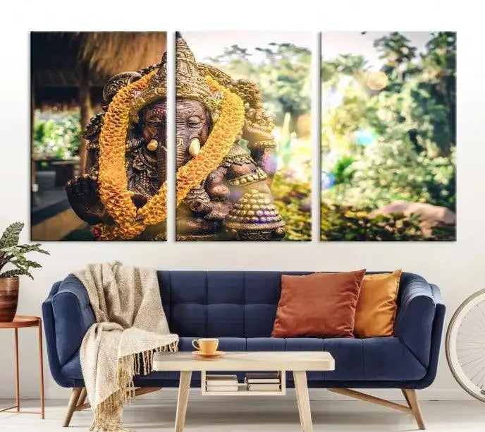 A set of three panels depicting the Hindu deity Lord Ganesha, embellished with a yellow garland, gracefully decorates a wall. This gallery-wrapped artwork, known as the Hinduism Statue Wall Art Canvas Print, is meticulously crafted on museum-quality canvas for an exquisite finish.