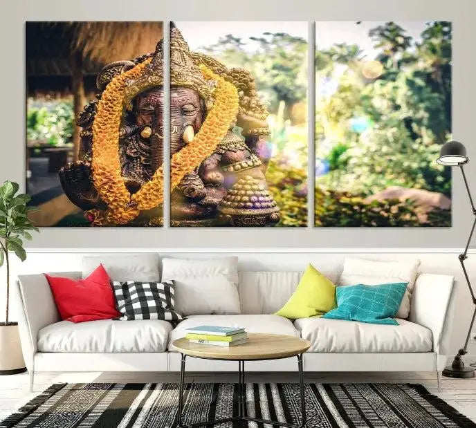 A set of three panels depicting the Hindu deity Lord Ganesha, embellished with a yellow garland, gracefully decorates a wall. This gallery-wrapped artwork, known as the Hinduism Statue Wall Art Canvas Print, is meticulously crafted on museum-quality canvas for an exquisite finish.