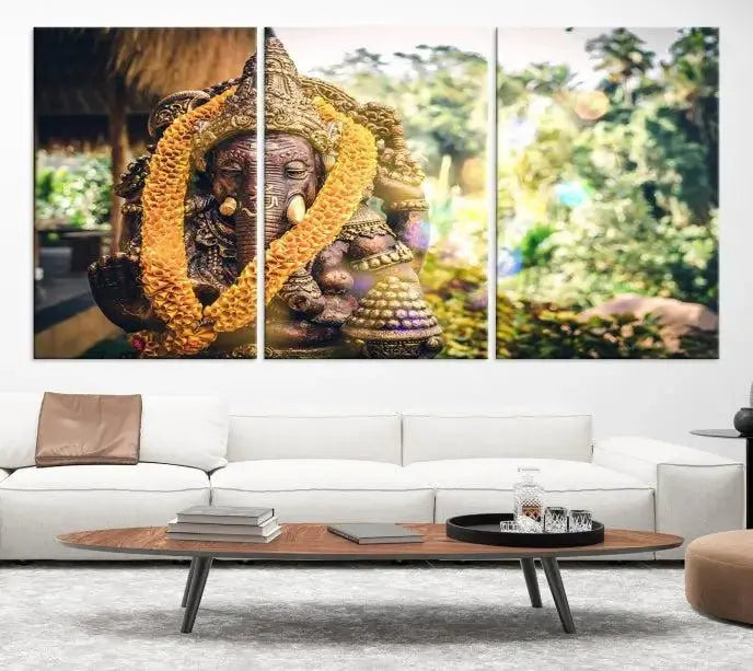 A set of three panels depicting the Hindu deity Lord Ganesha, embellished with a yellow garland, gracefully decorates a wall. This gallery-wrapped artwork, known as the Hinduism Statue Wall Art Canvas Print, is meticulously crafted on museum-quality canvas for an exquisite finish.