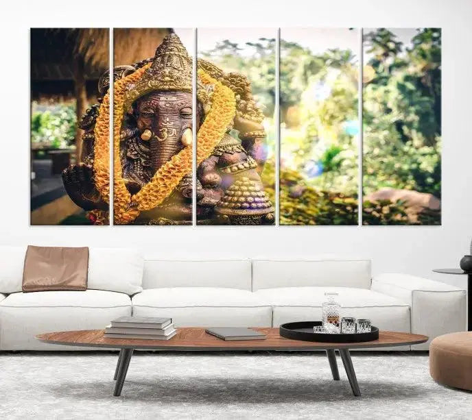 A set of three panels depicting the Hindu deity Lord Ganesha, embellished with a yellow garland, gracefully decorates a wall. This gallery-wrapped artwork, known as the Hinduism Statue Wall Art Canvas Print, is meticulously crafted on museum-quality canvas for an exquisite finish.