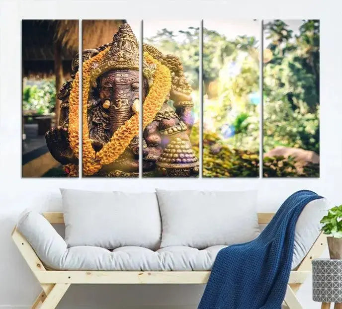 A set of three panels depicting the Hindu deity Lord Ganesha, embellished with a yellow garland, gracefully decorates a wall. This gallery-wrapped artwork, known as the Hinduism Statue Wall Art Canvas Print, is meticulously crafted on museum-quality canvas for an exquisite finish.