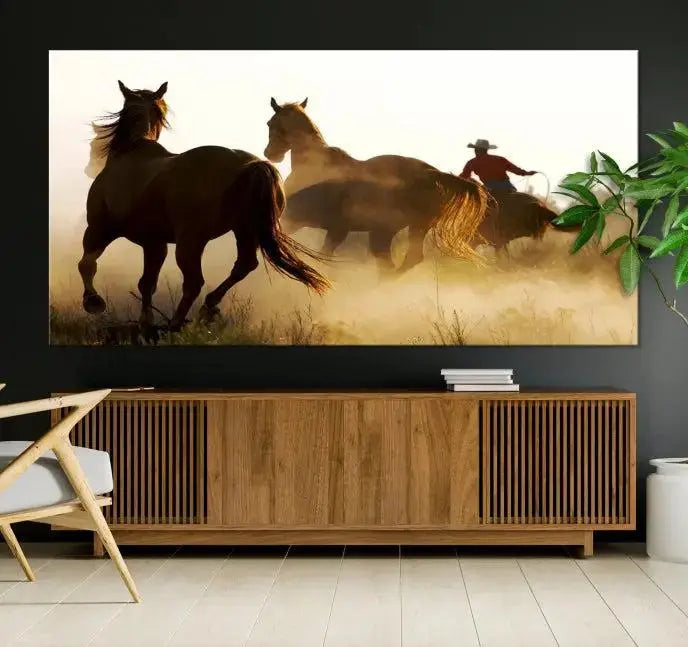 Introducing the "Horses and Cowboys Wall Art Canvas Print": a stunning three-panel artwork featuring horses and a rider, highlighted by the silhouette of a cowboy amidst a dusty sunset landscape. This masterpiece is crafted on museum-quality canvas, with each section gallery wrapped and finished with a UV-protective coating to maintain its vividness and elegance over time.