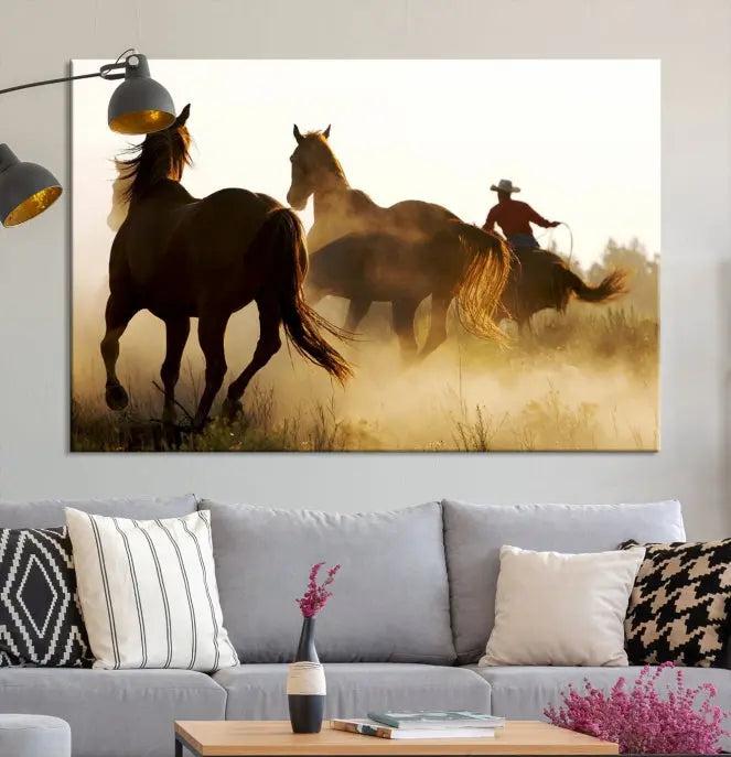 Introducing the "Horses and Cowboys Wall Art Canvas Print": a stunning three-panel artwork featuring horses and a rider, highlighted by the silhouette of a cowboy amidst a dusty sunset landscape. This masterpiece is crafted on museum-quality canvas, with each section gallery wrapped and finished with a UV-protective coating to maintain its vividness and elegance over time.